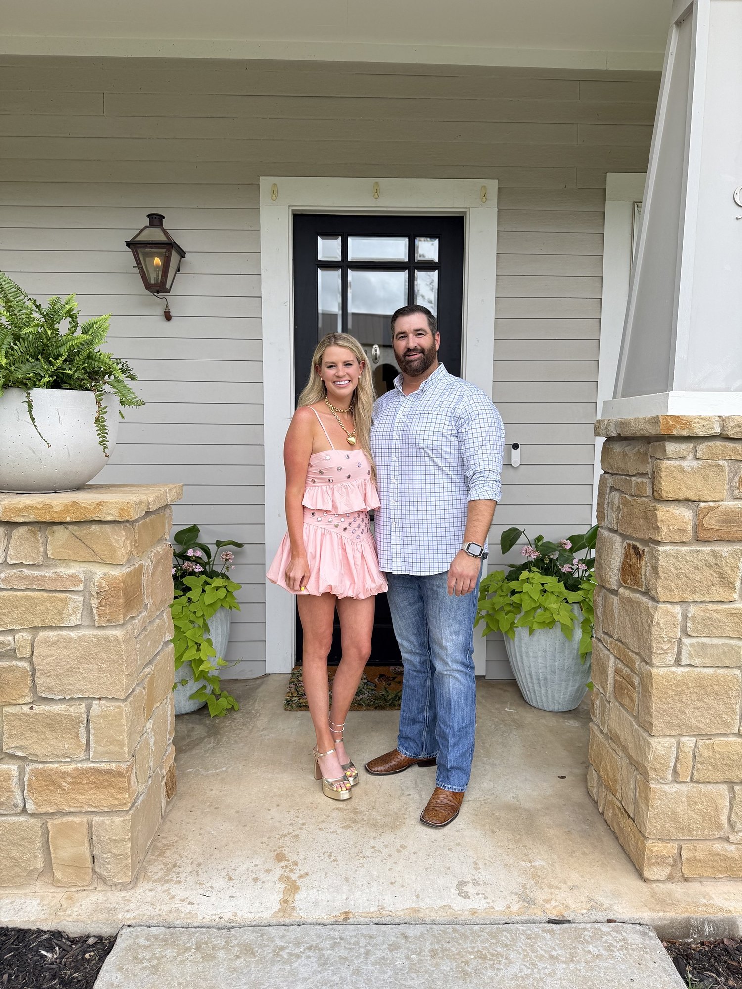 Savannah Sikes and her husband David on the front porch of their home near downtown Fredericksburg
